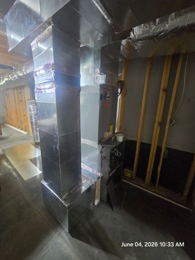 Basement utility room with water heater, furnace, pipes, and storage shelves