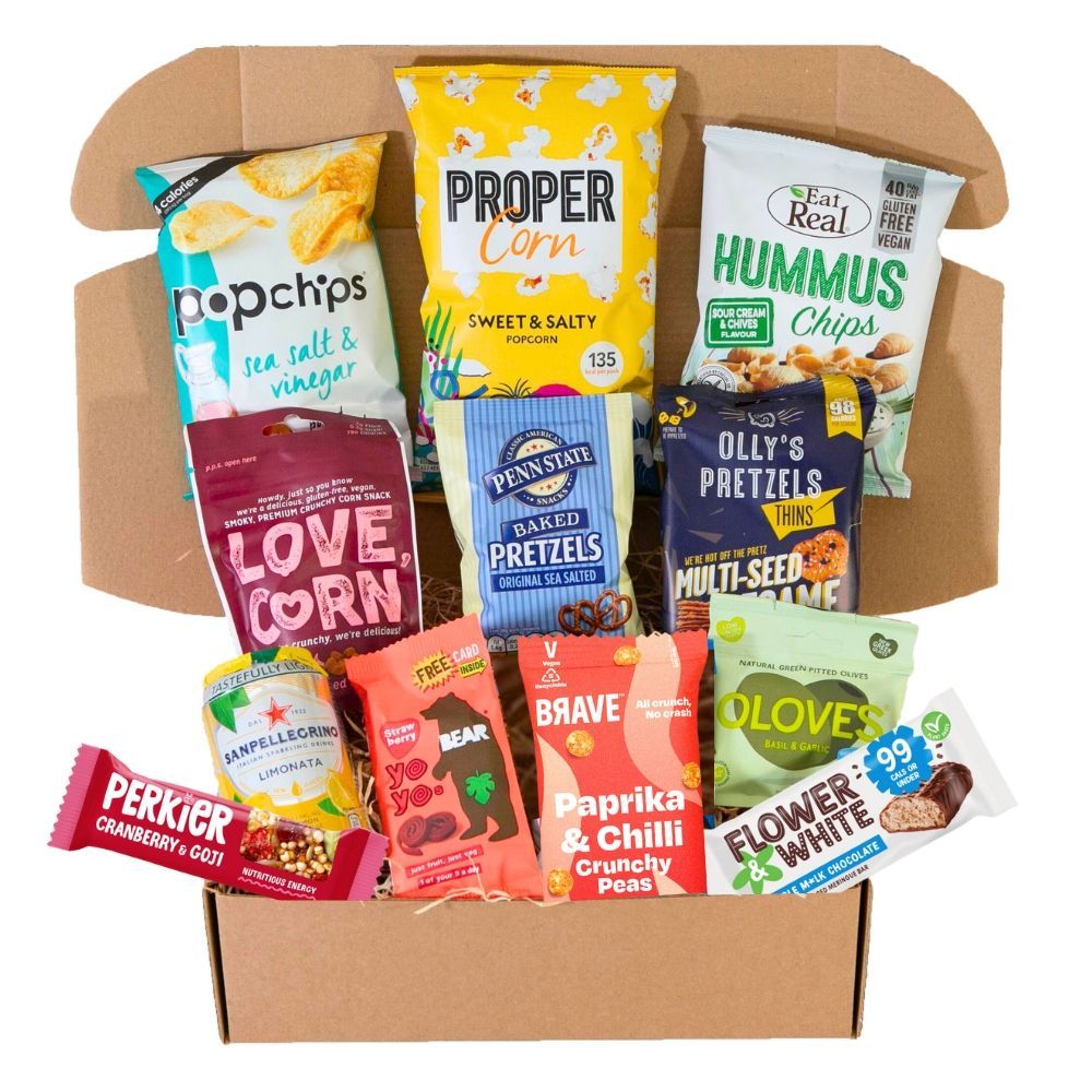 A box filled with a variety of snacks including pretzels and hummus chips.