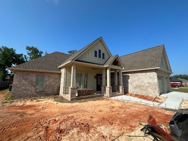 A picture of a new construction house with tan seamless gutters in Covington, LA