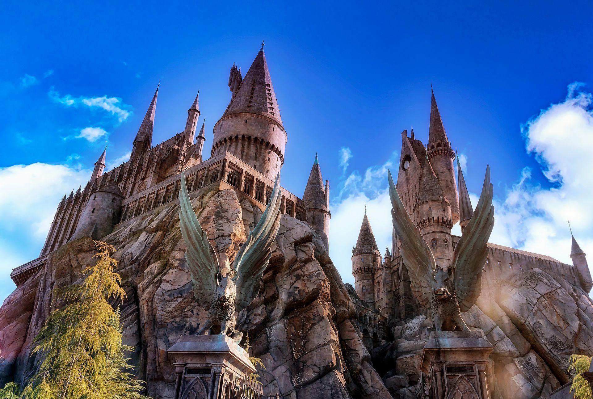 A large castle sitting on top of a hill with a blue sky in the background.