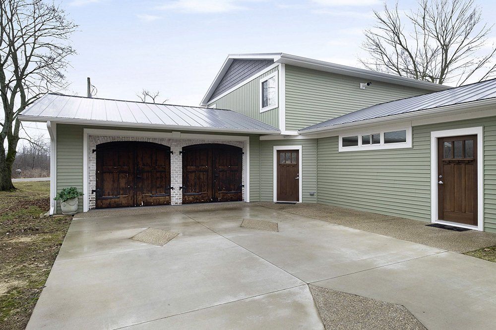 A house with a garage and a custom concrete driveway in front of it.