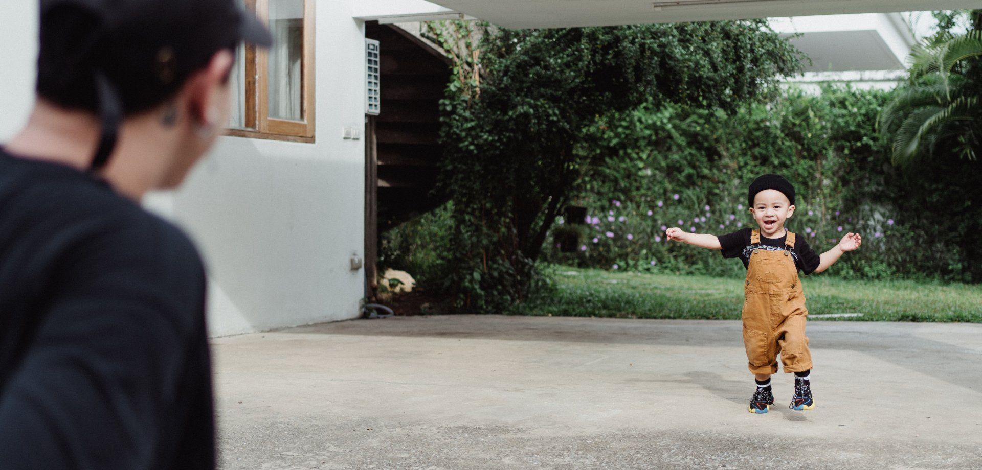 child walking across concrete patio pad