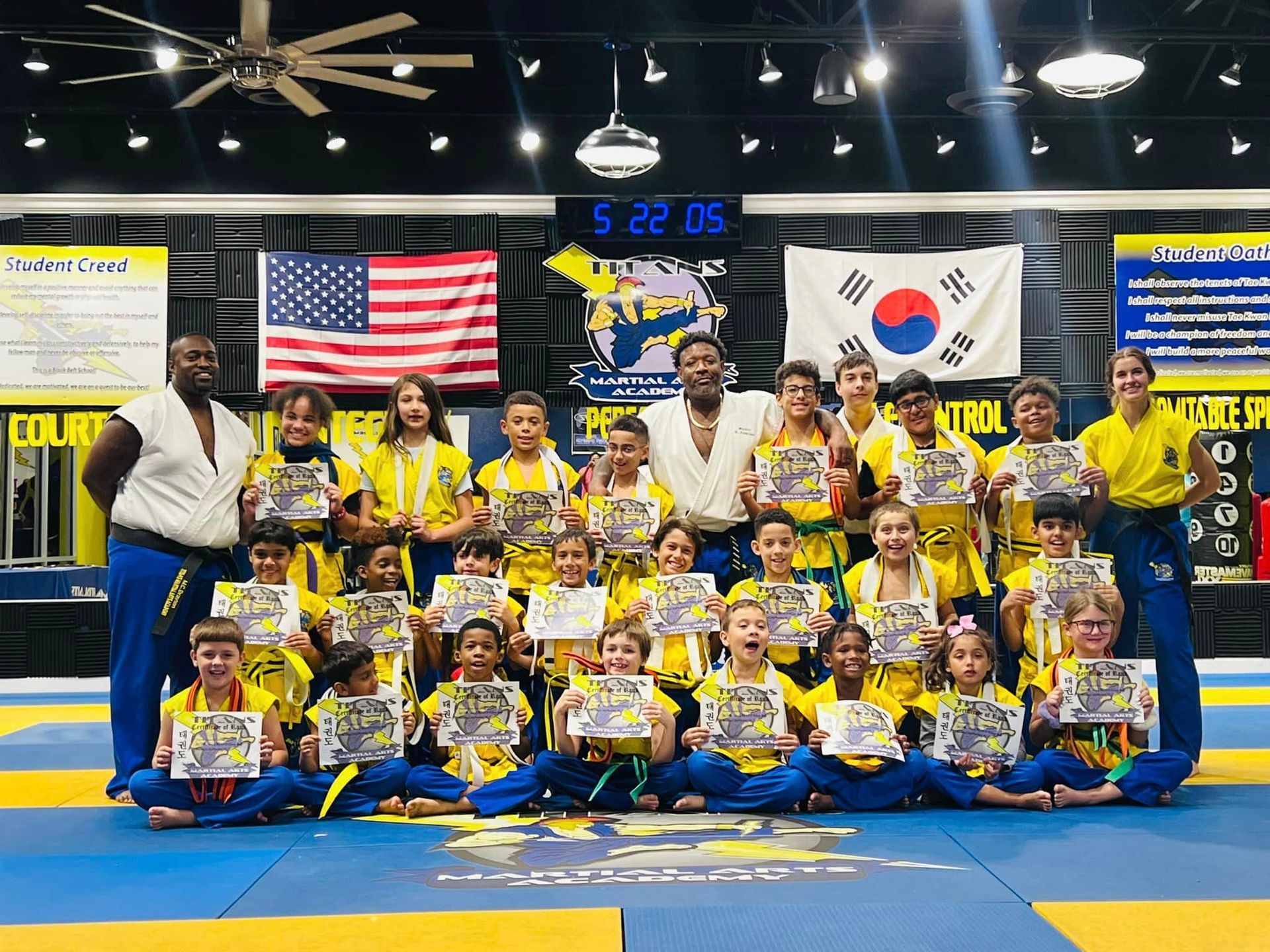 A group of children are posing for a picture in a gym.