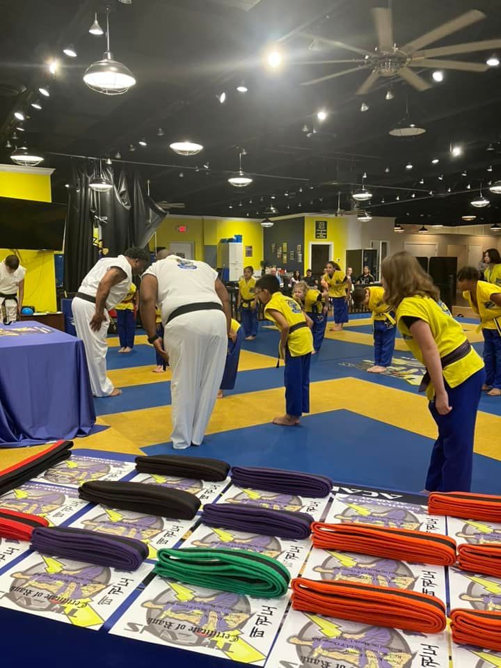 A group of people are practicing martial arts in a gym.