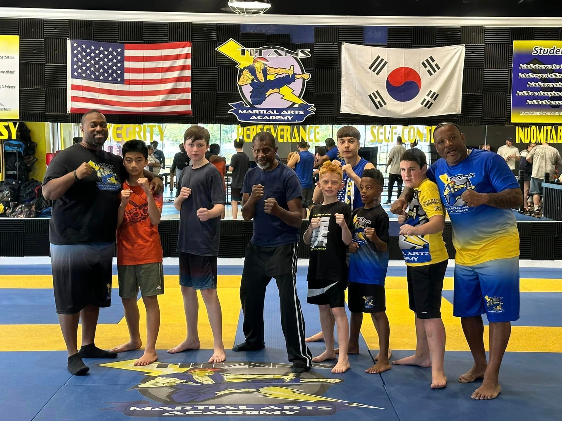 A group of young men are posing for a picture in a gym.