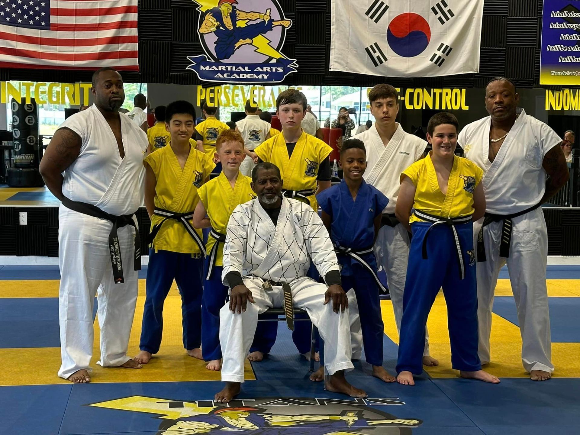 A group of people in karate uniforms are posing for a picture.
