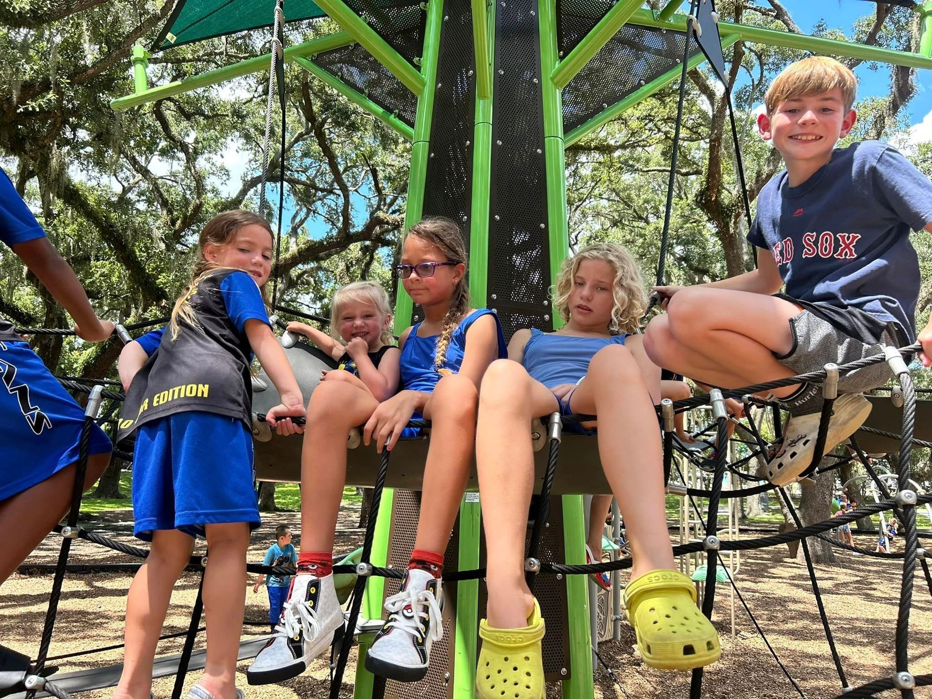 A group of kids climbing on the rope