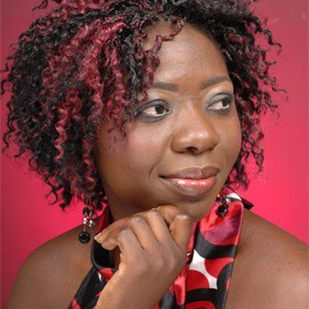 A woman with curly hair and a scarf around her neck