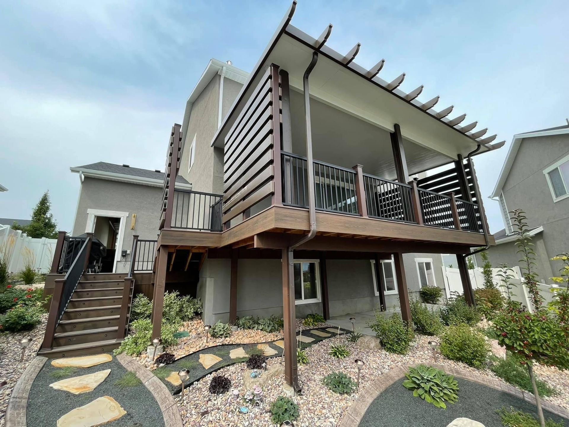 A house with a large deck and stairs leading up to it.
