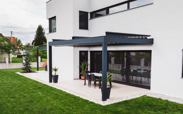 Modern concrete patio with simple black furnishings