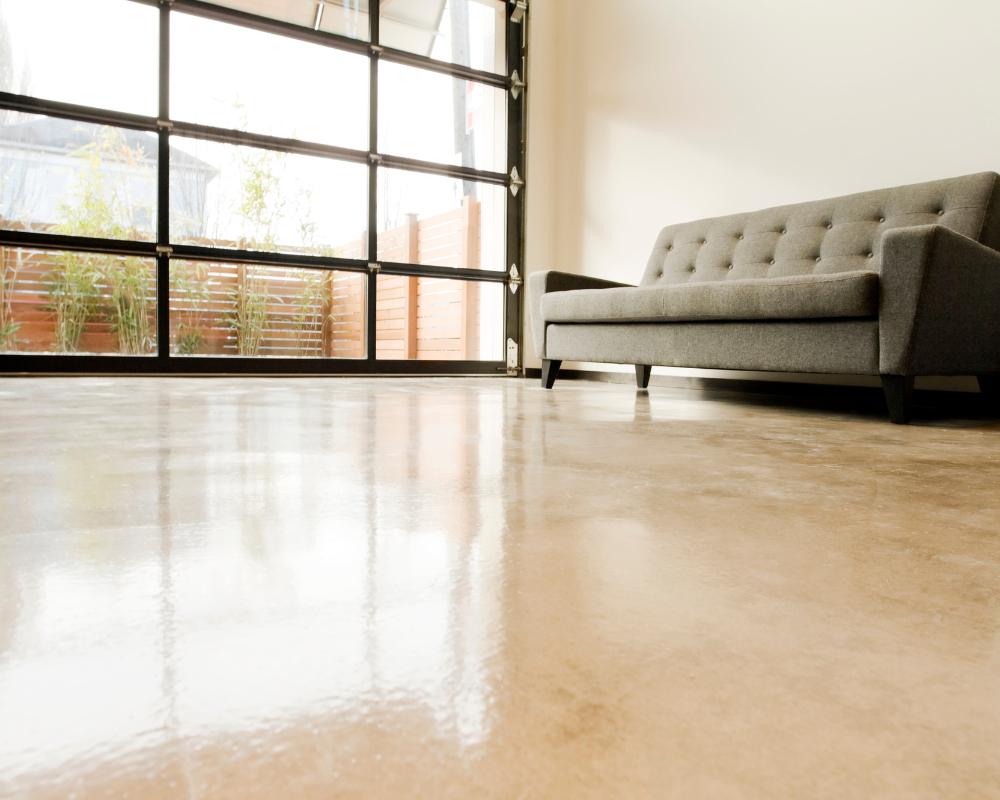 tan epoxy flooring with a grey couch