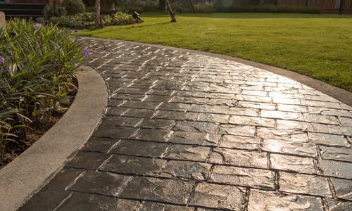 sunset casting over a stamped concrete sidewalk