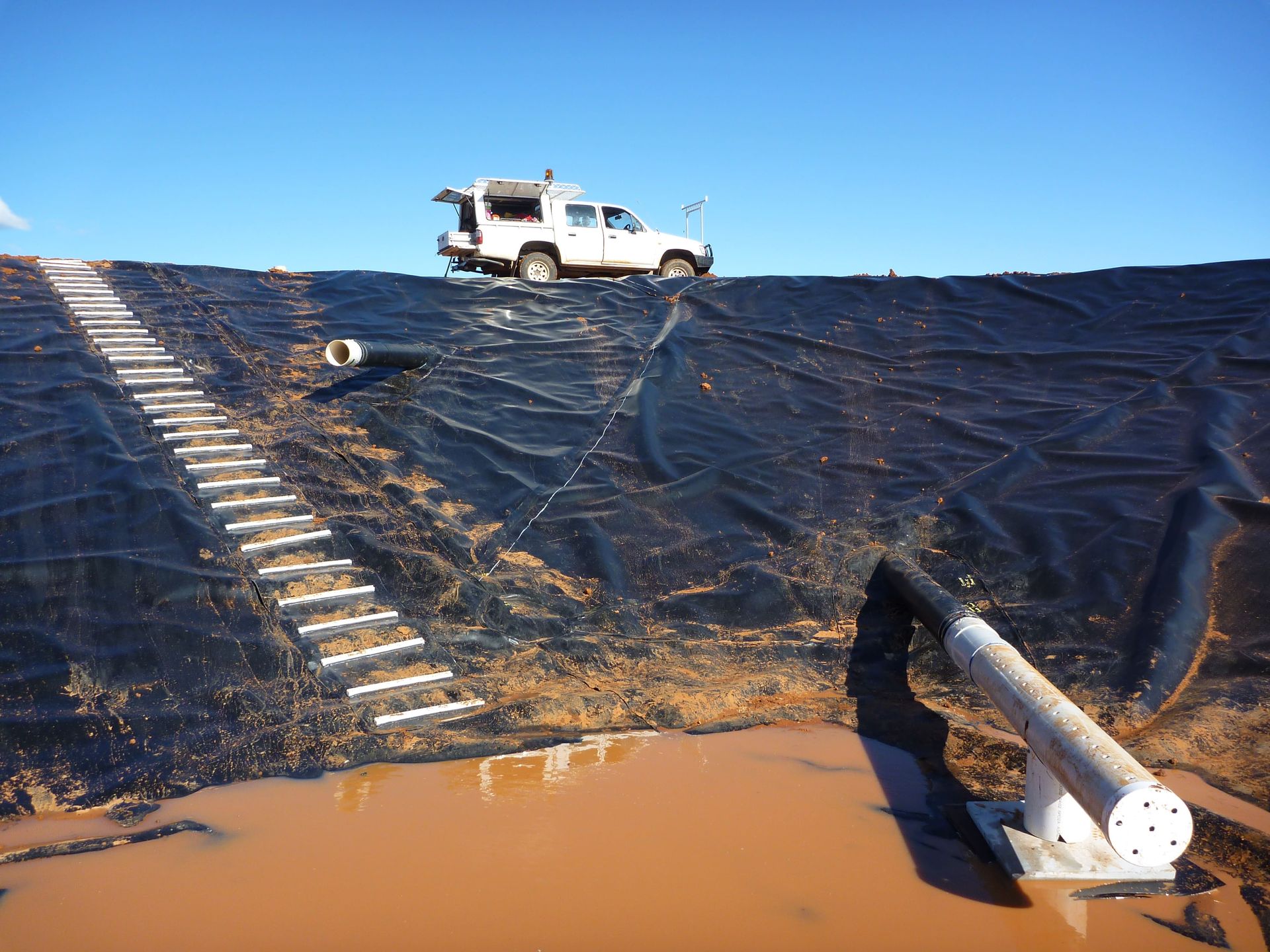 A white truck is parked on top of a black tarp | Murray Bridge, SA | Ridleys SA