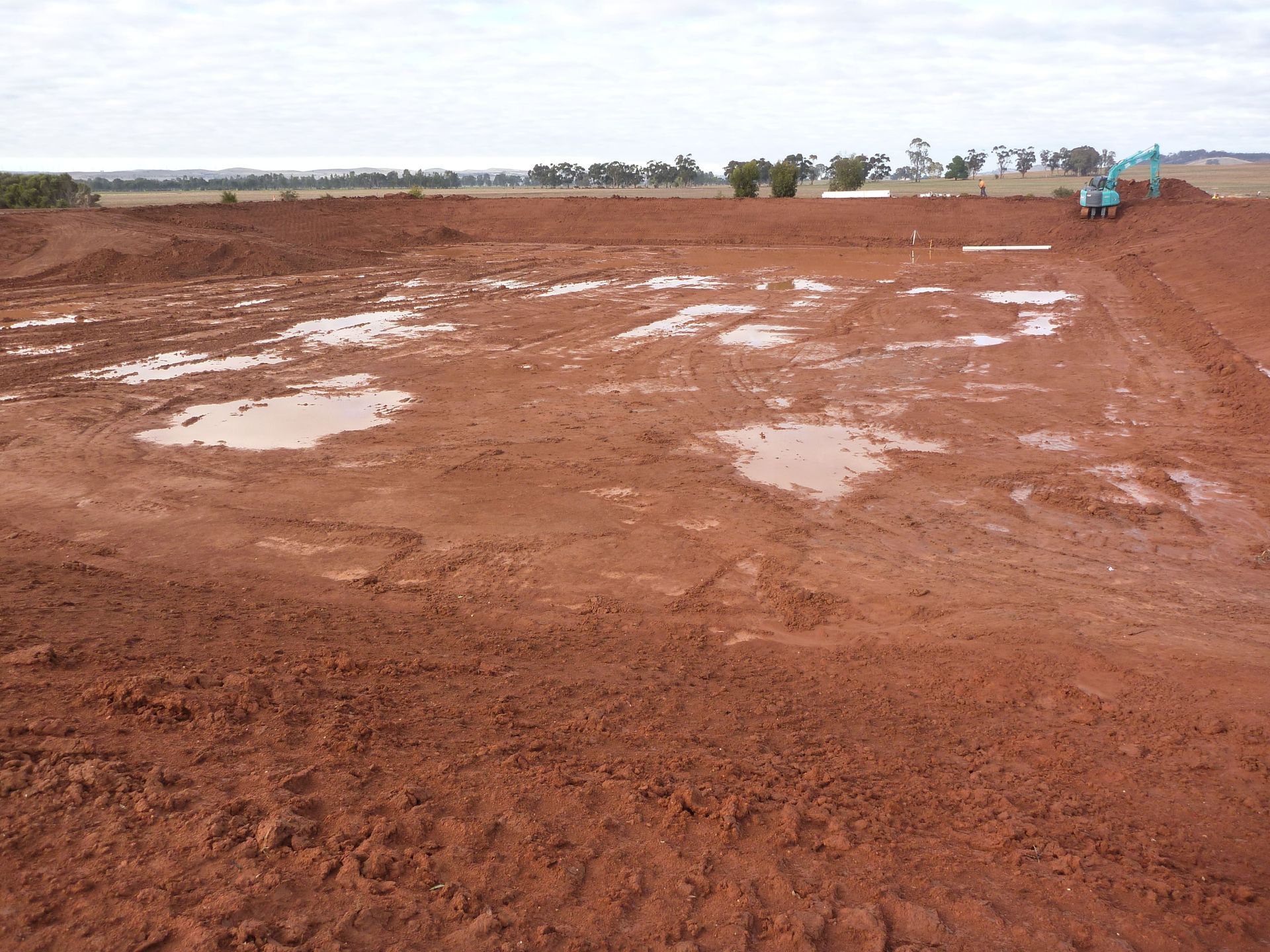 A muddy field with a blue excavator in the background | Murray Bridge, SA | Ridleys SA