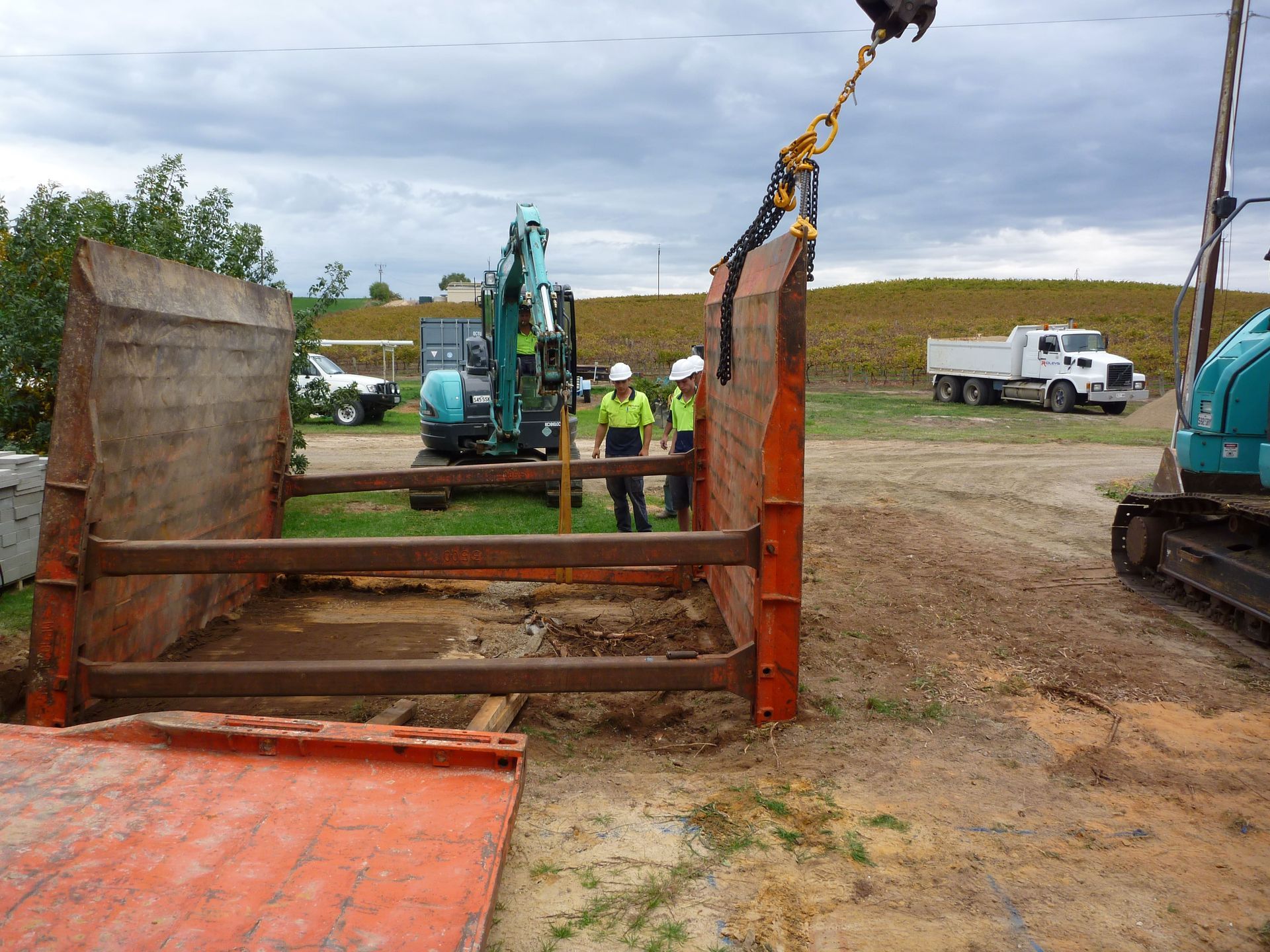 A blue excavator is being lifted by a chain | Murray Bridge, SA | Ridleys SA