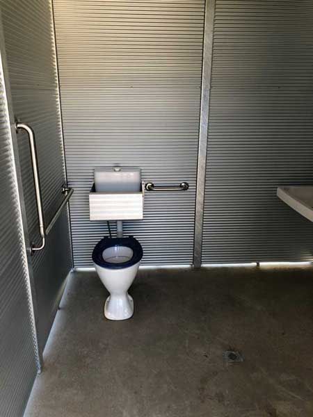 A bathroom with a toilet , sink , and handrails | Murray Bridge, SA | Ridleys, SA 