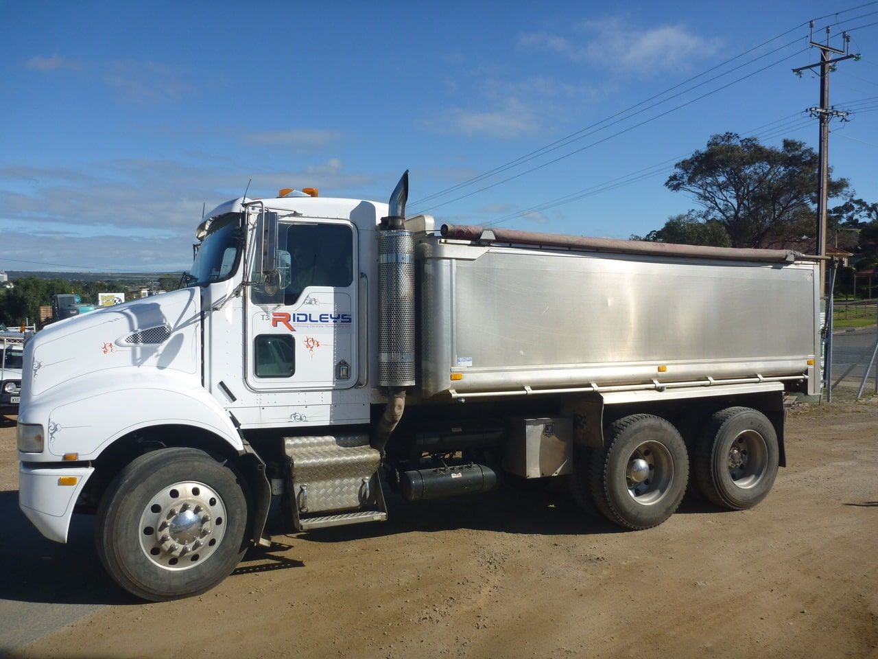 A white ridleys dump truck is parked on a dirt road | Murray Bridge, SA | Ridleys SA