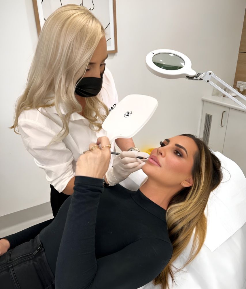 A woman is getting an injection in her face while wearing a mask — Sibina Cosmetic Tattoo Art In Broadbeach, QLD
