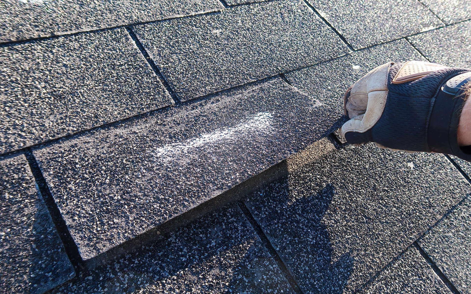 A person is cleaning a roof with a sponge.