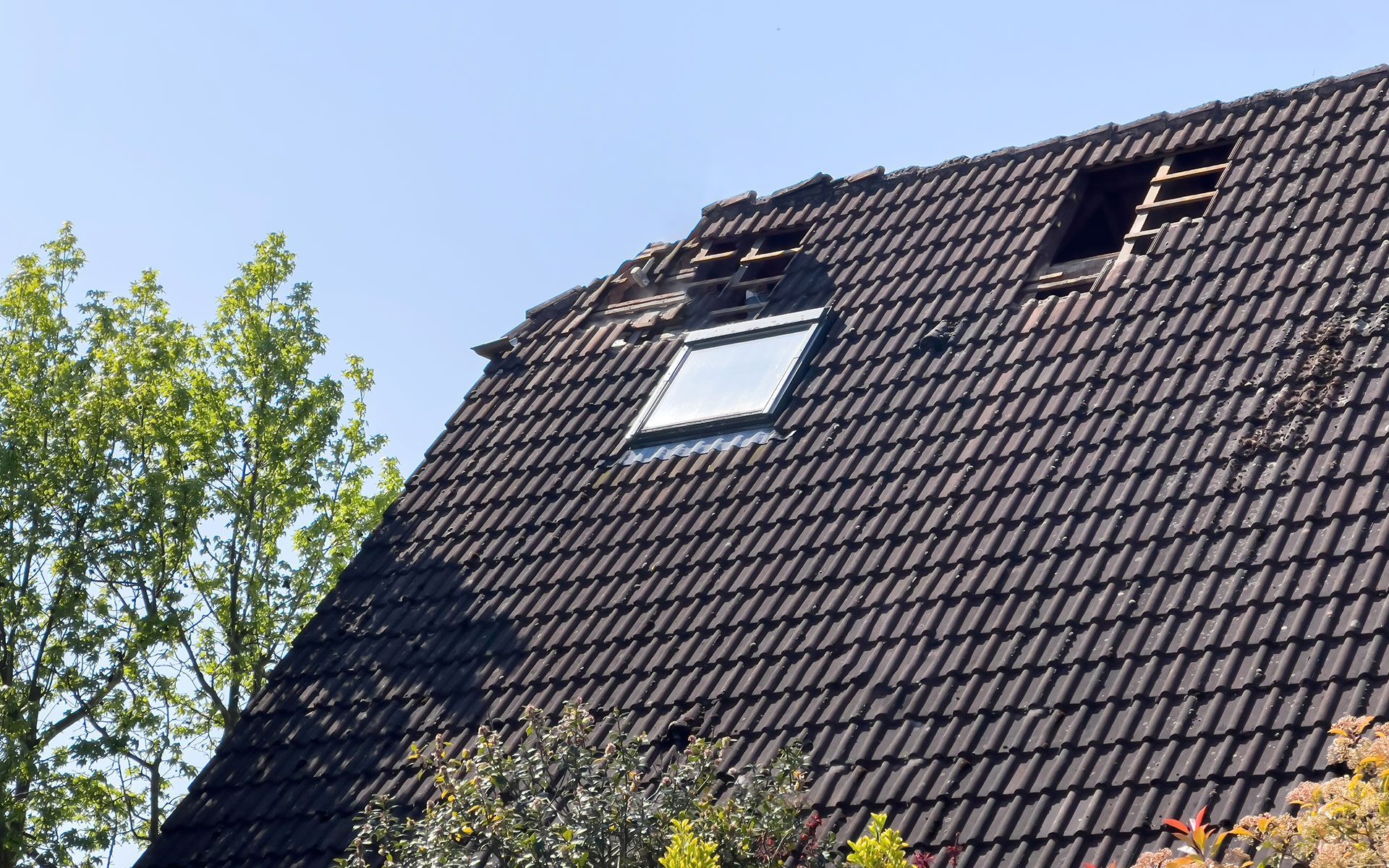 A roof with a skylight and a hole in it