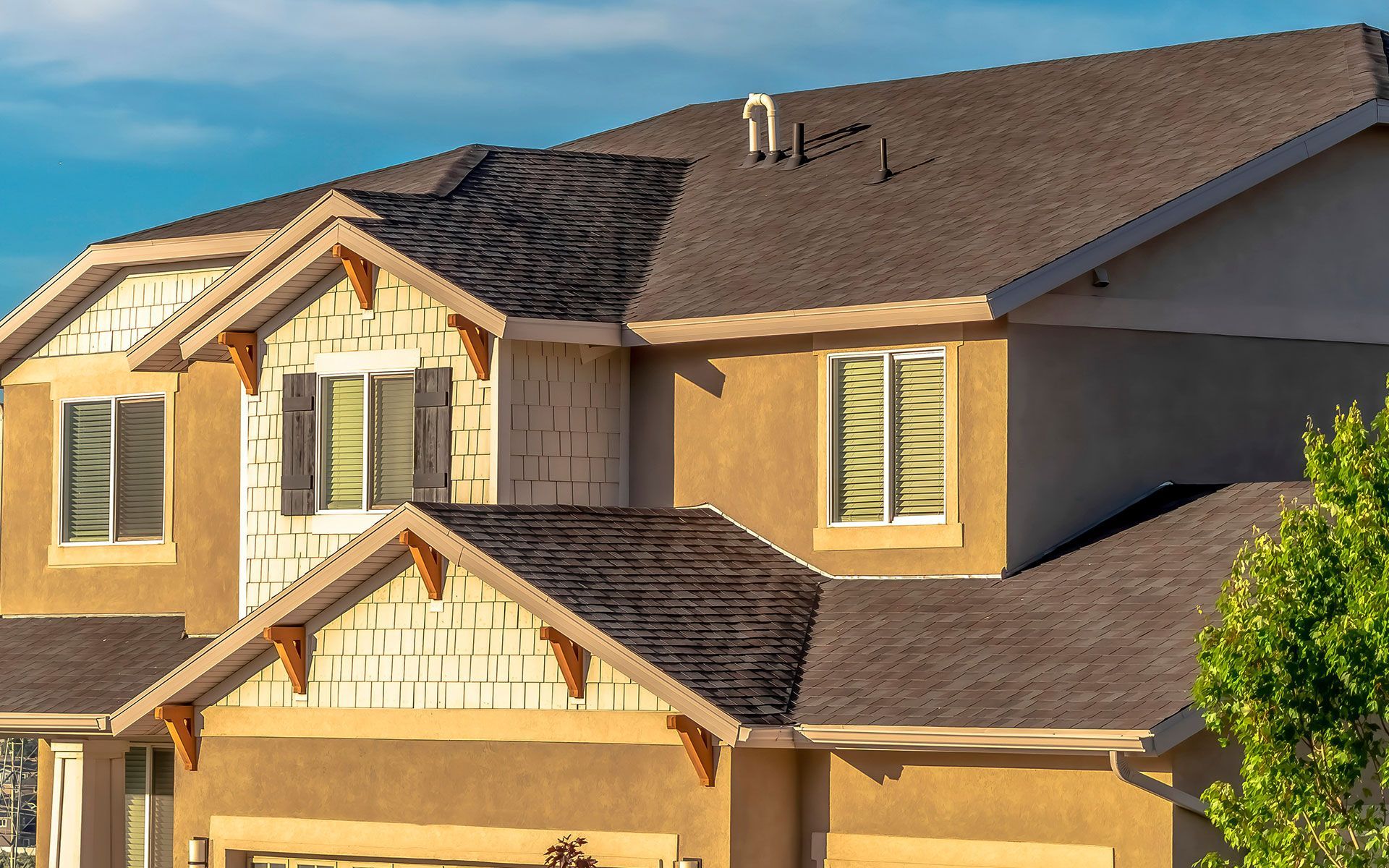 A large house with a brown roof and a lot of windows.