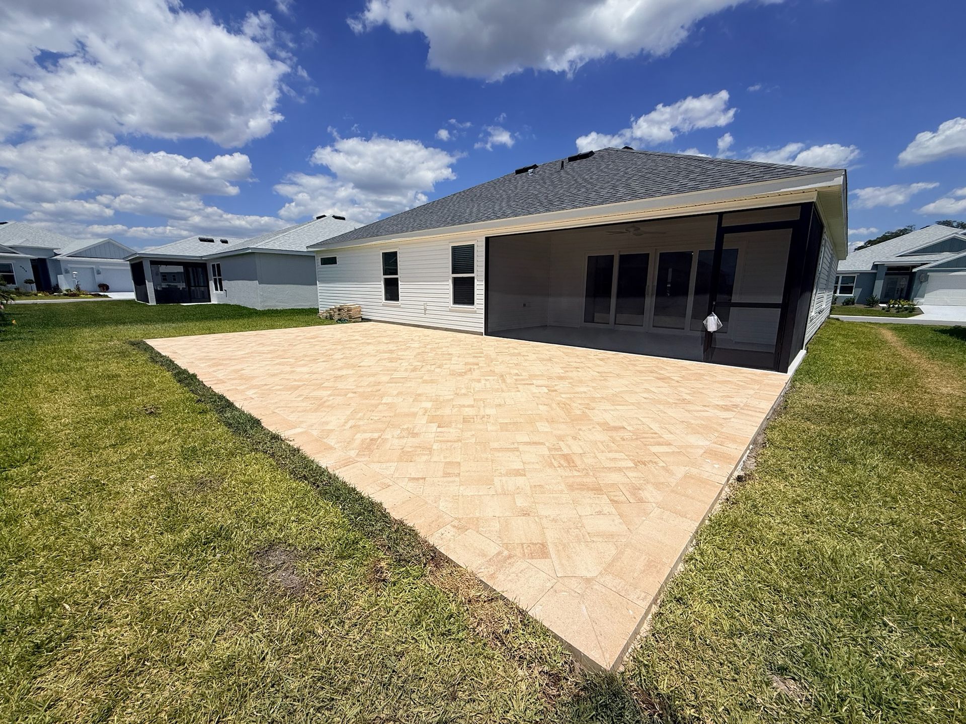 Before picture of a white house with new pavers.