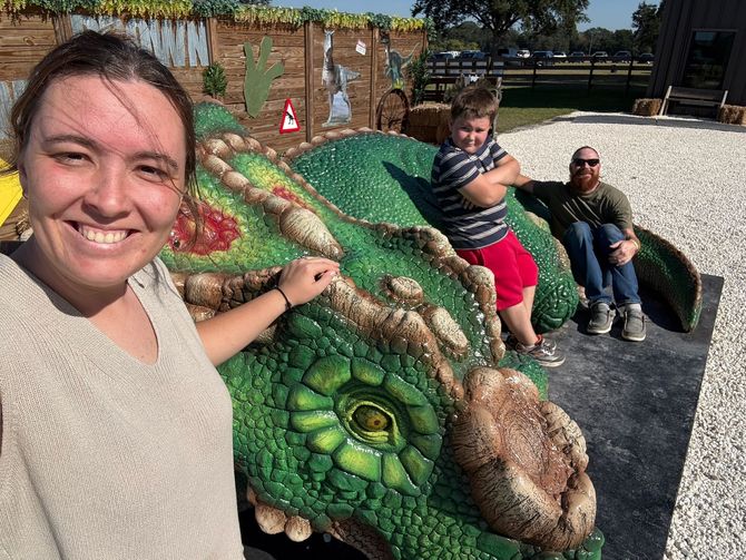 Dino Screens & Aluminum family hanging out with a dinosaur