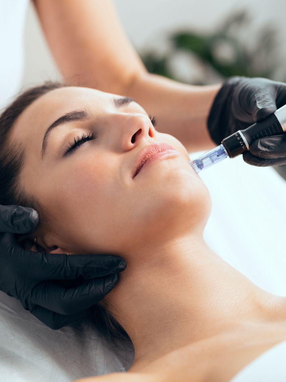 A woman is getting a facial treatment at a beauty salon.