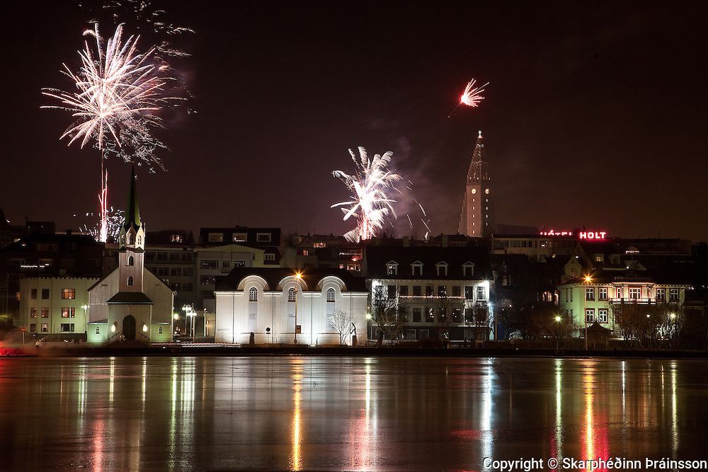 New Year's Eve fireworks lighting up the night sky over Reykjavík, Iceland