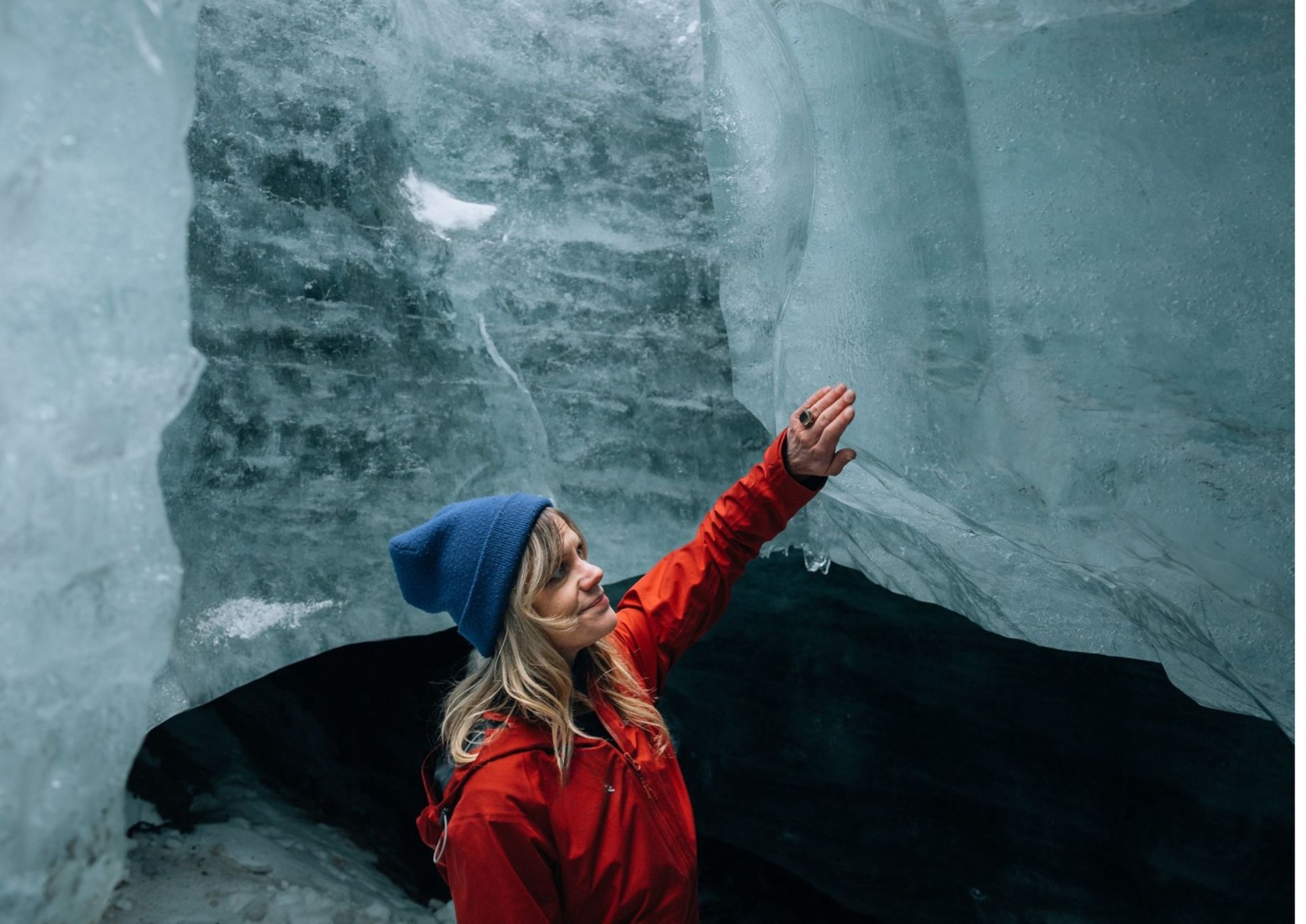 Touching the blue ice of Neptune natural ice cave