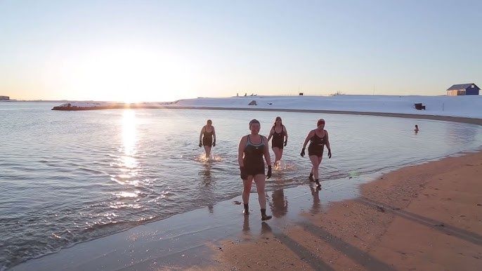 People bathing in the ocean at Nautholsvik beach in Reykjavik