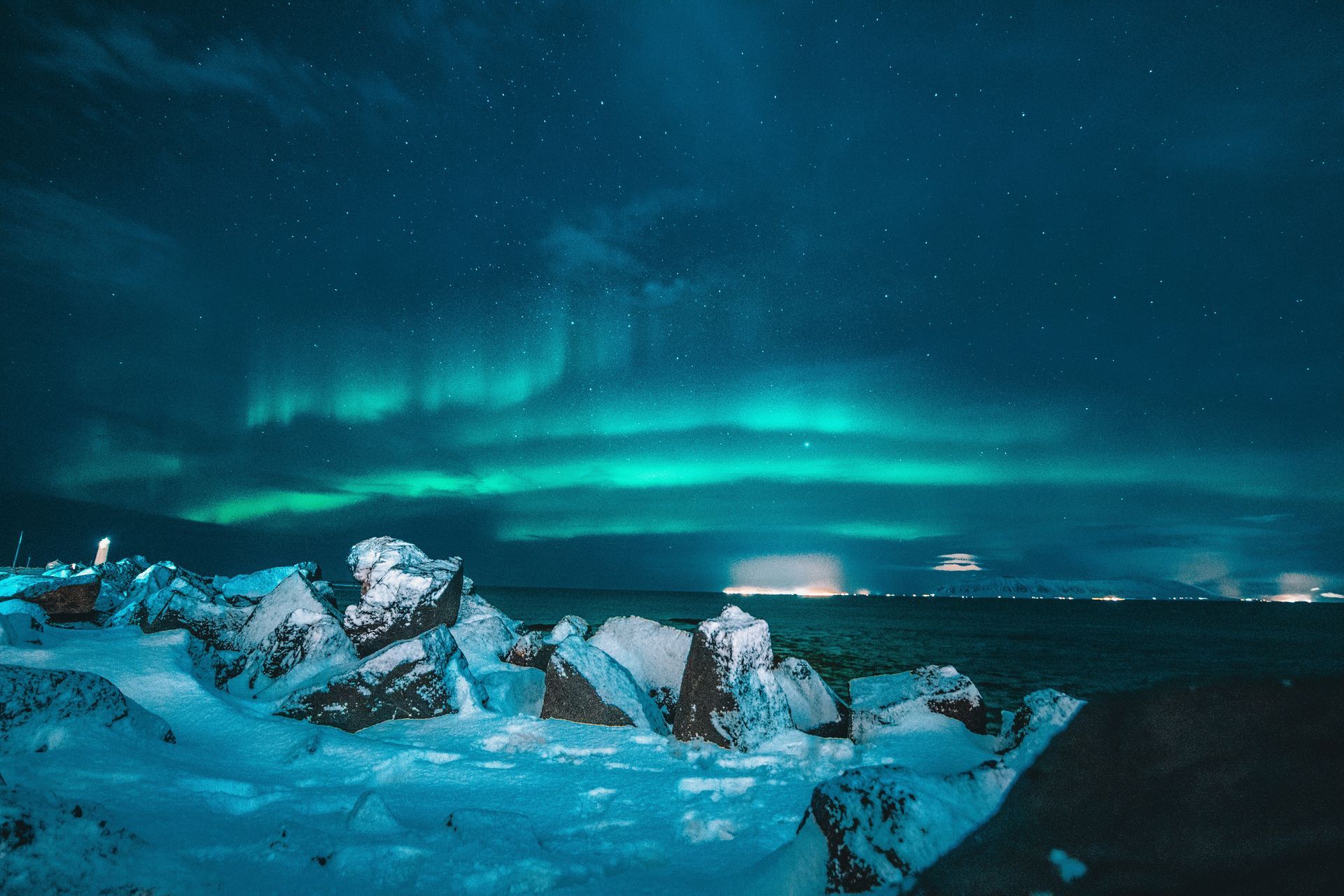 Northern Lights across the sky above a snowy field