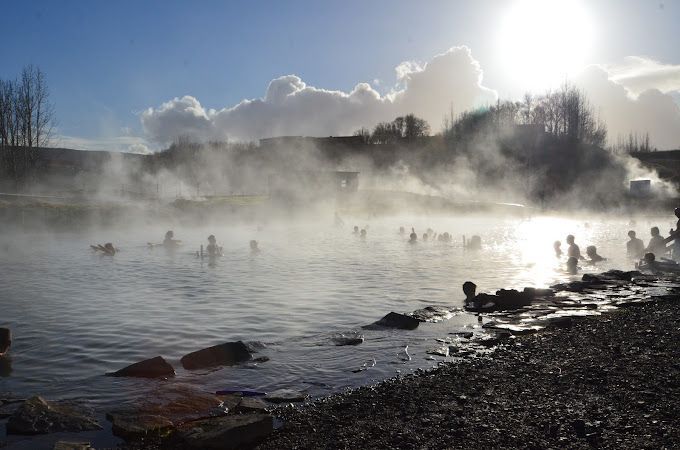 Guests bathing in the Secret lagoon in Fluðir village