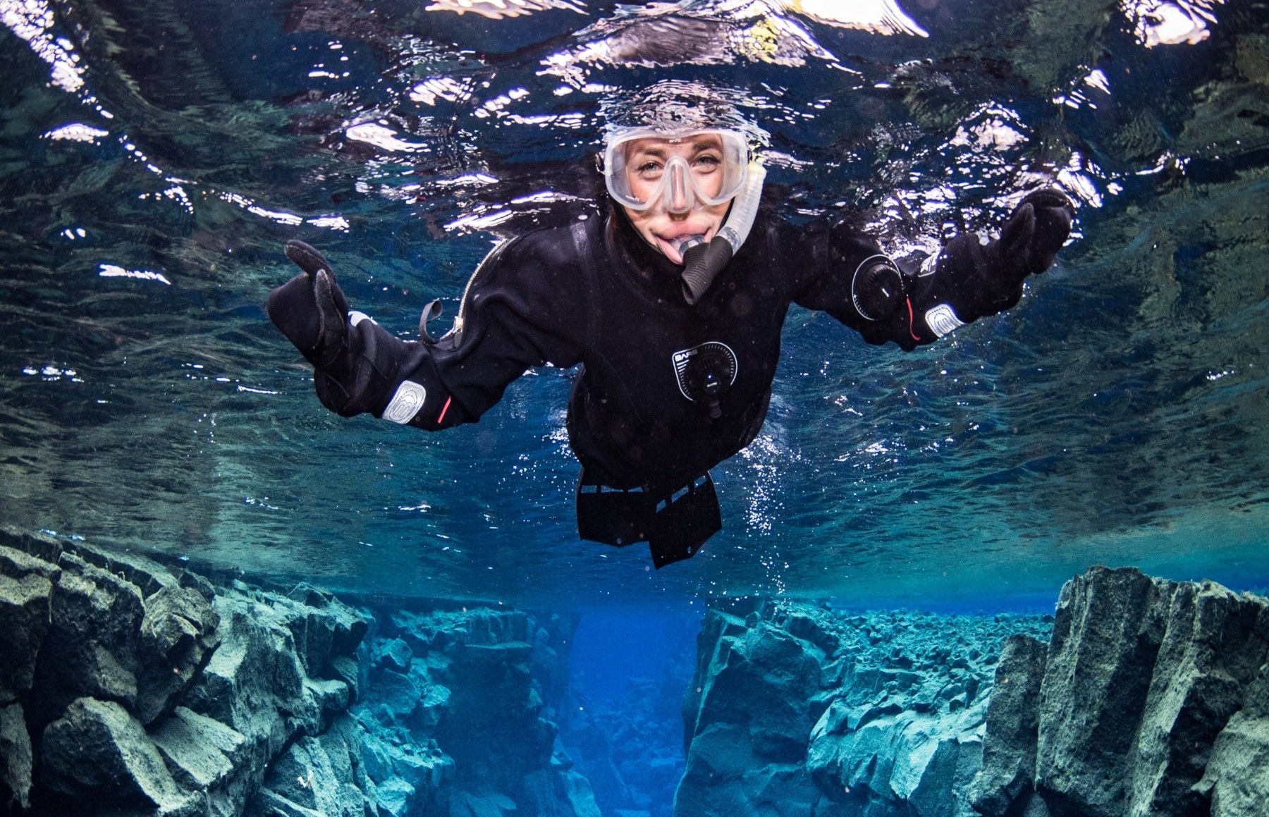 Person snorkeling in Silfra fissure at Thingvellir National Park