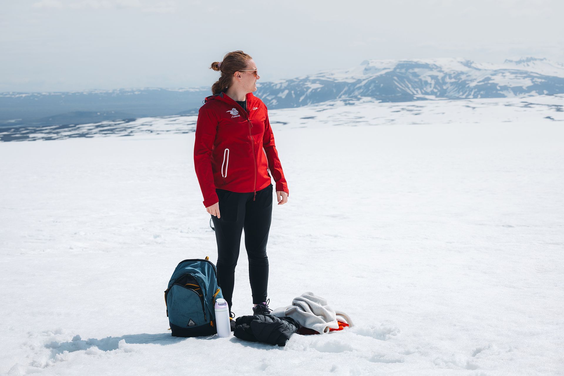 Guests standing on Langjökull glacier, enjoying the view to the mountains
