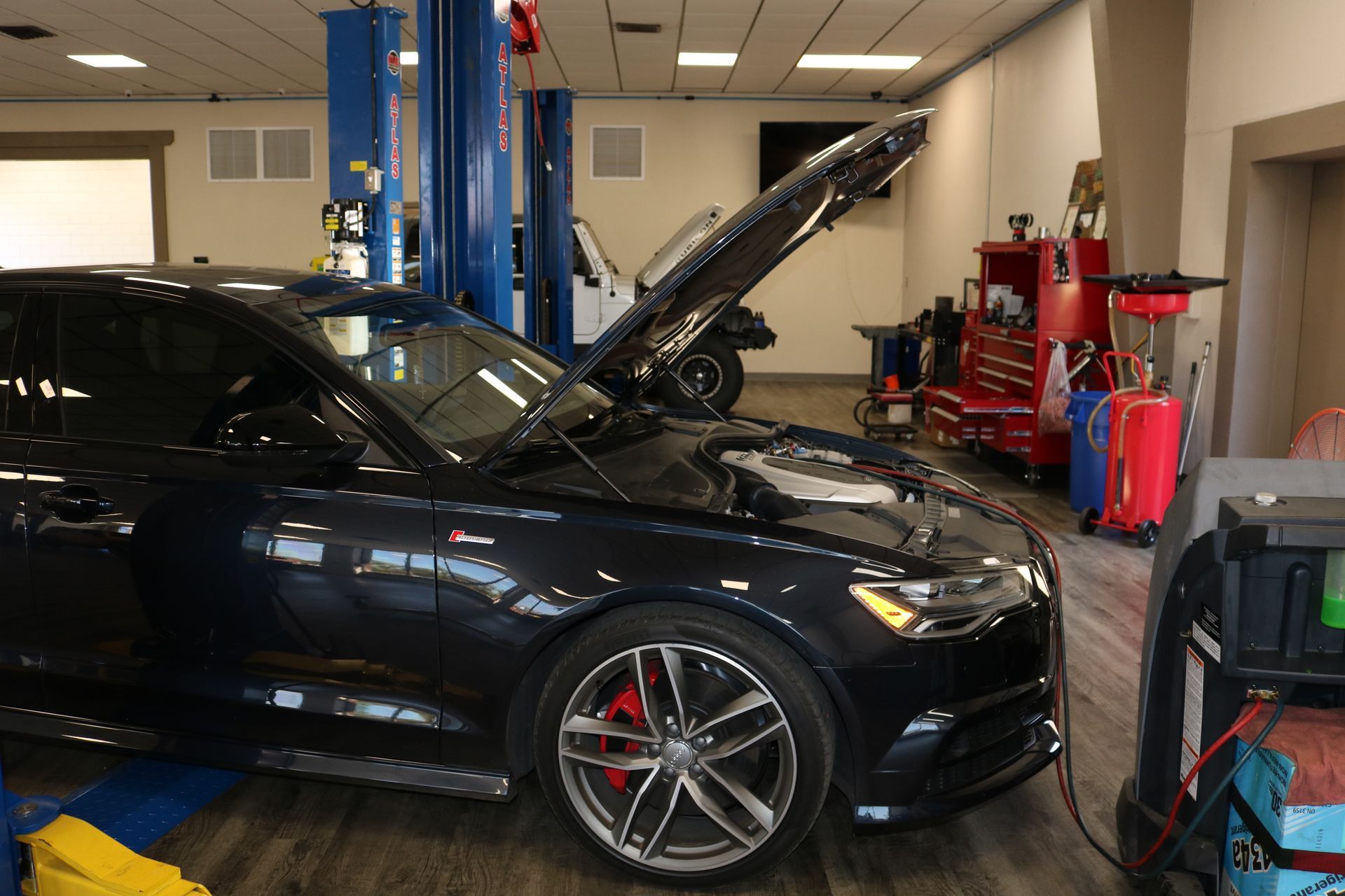 Black Car Inside of Auto Shop | Best Mechanic in Pensacola, FL - Pensacola AC & Auto Service Center