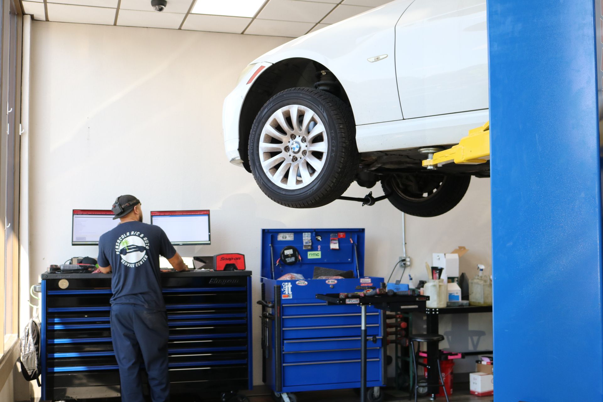 Mechanic Leaning into Tool Cabinet | Best Mechanic in Pensacola, FL - Pensacola AC & Auto Service Center