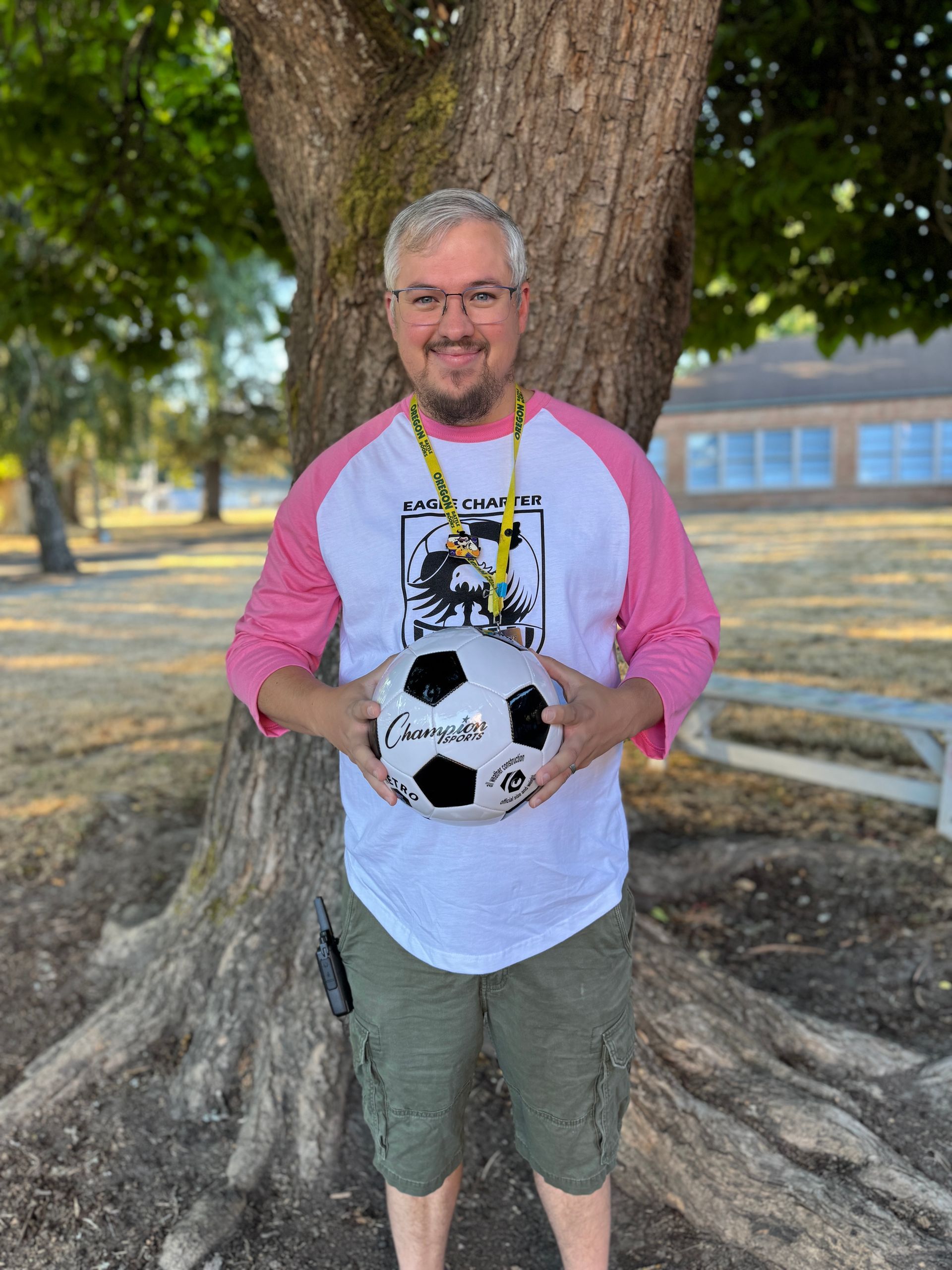 Media Specialist and Librarian. Holding a soccer ball.