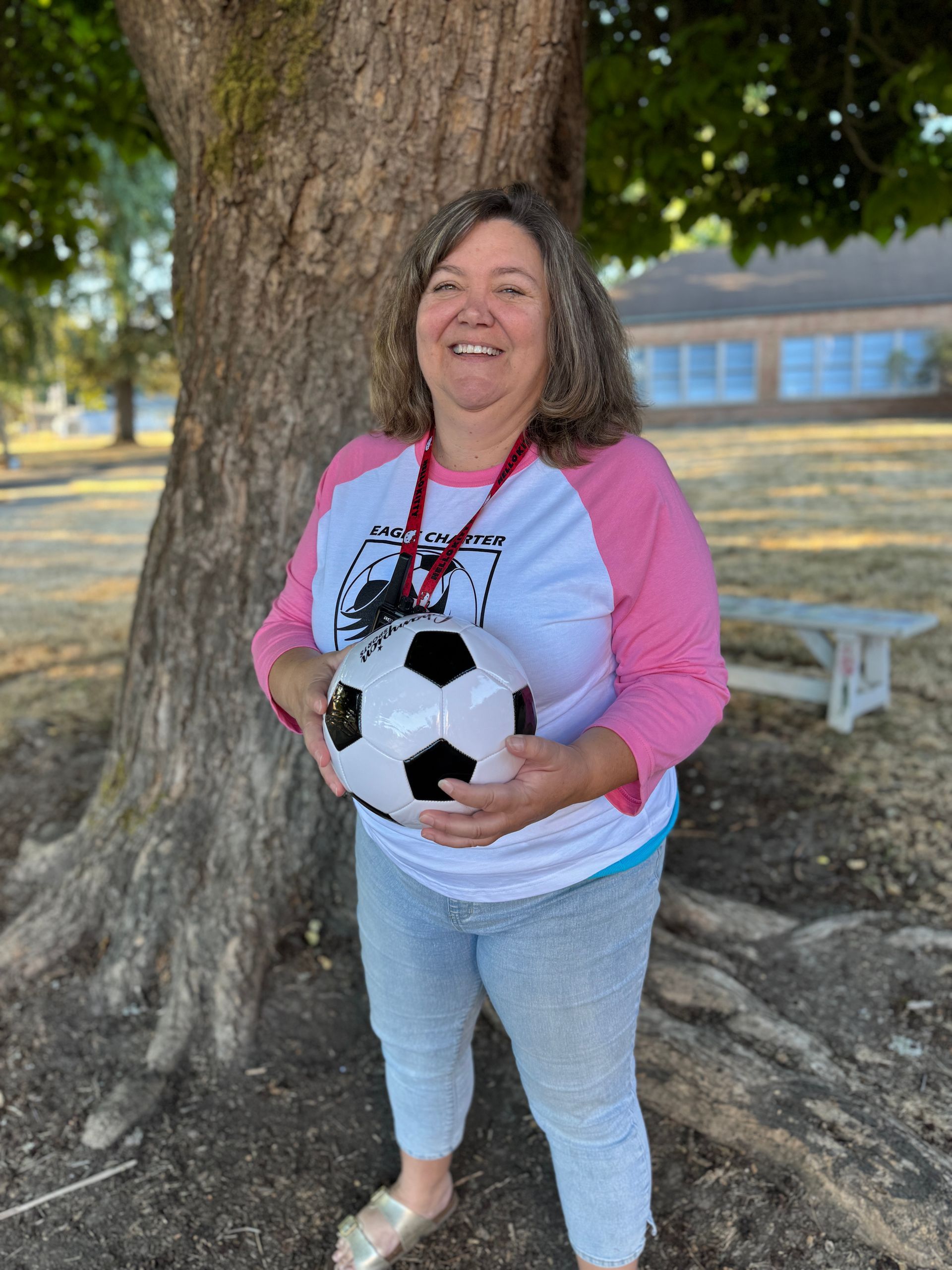 Fifth Grade Teacher. Holding a soccer ball.