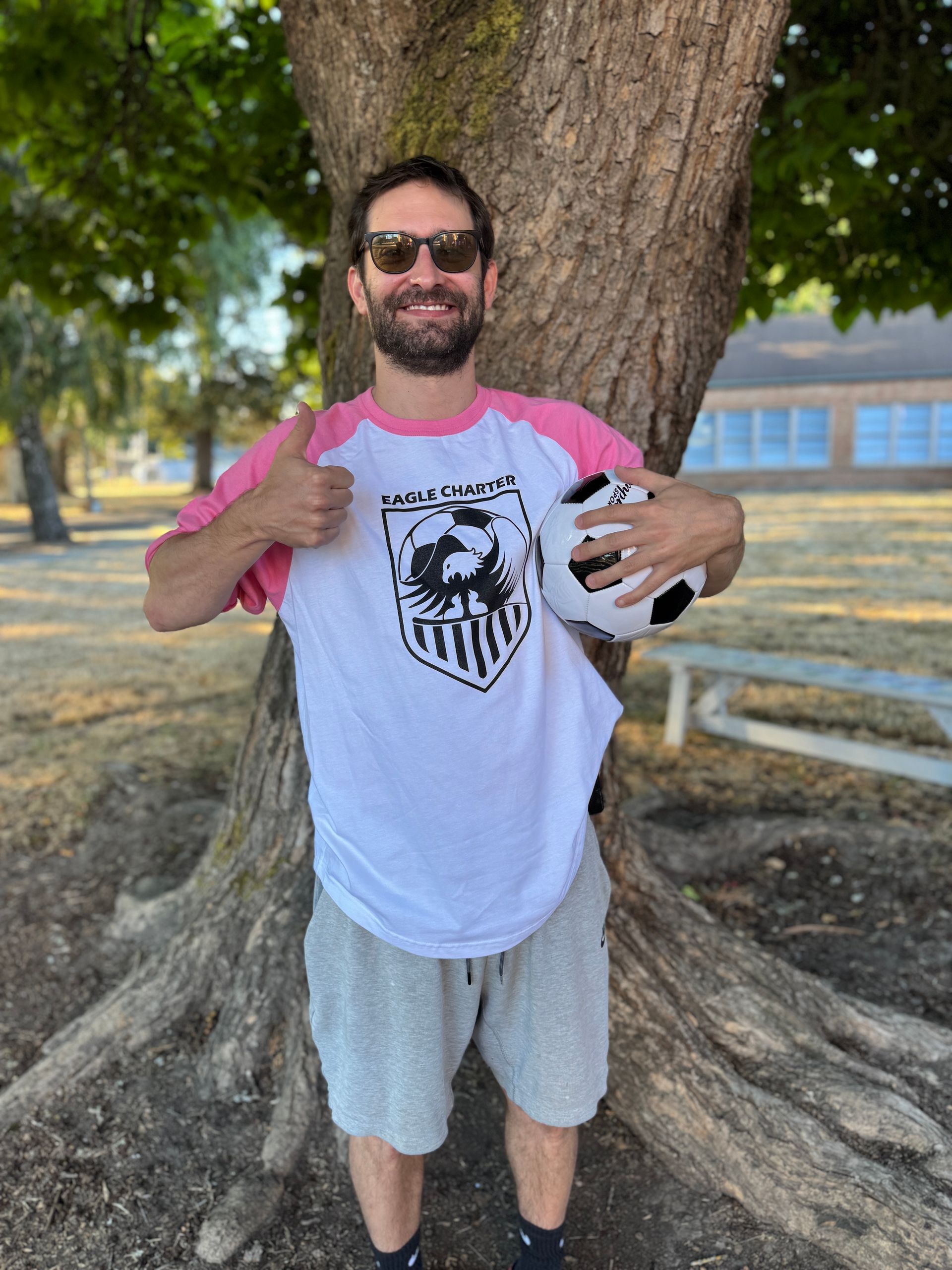 PE Teacher. Holding a soccer ball.