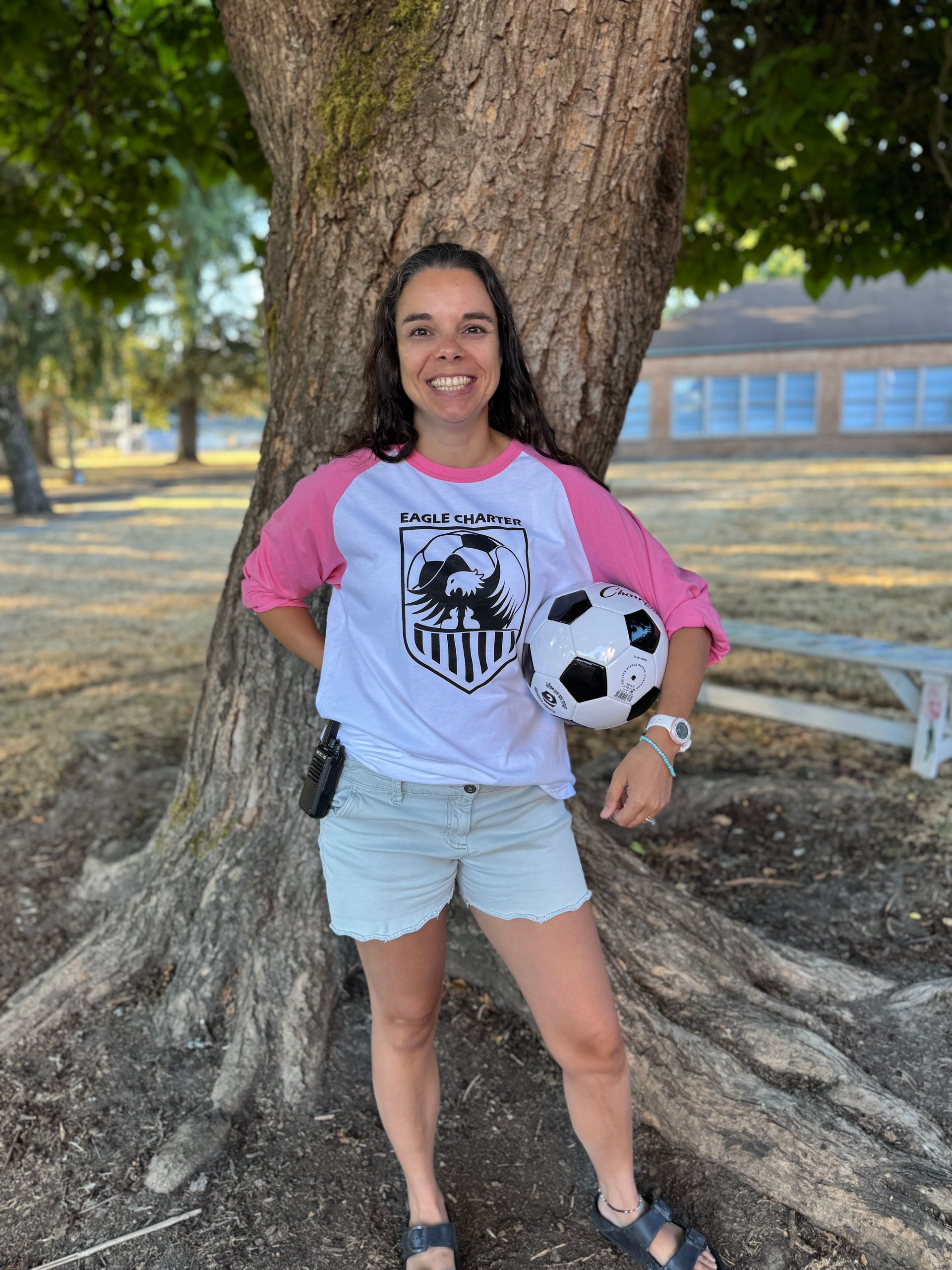 Office Manager. Holding a soccer ball.