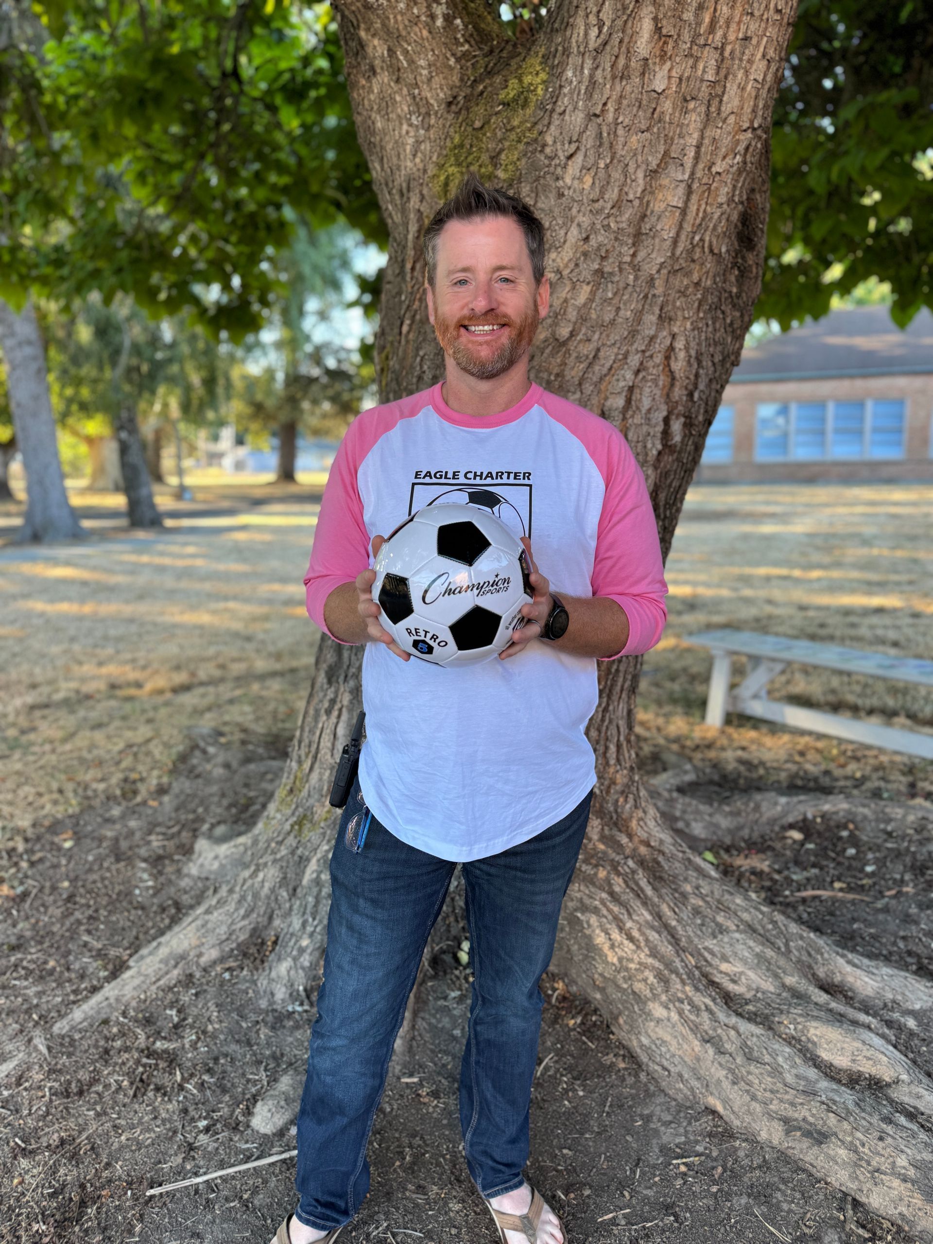First Grade Teacher. Holding a soccer ball.