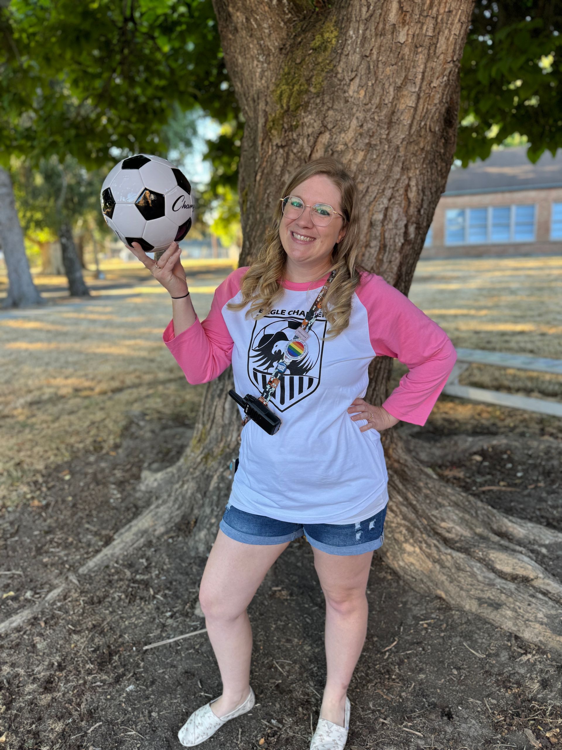 Learning Resource Specialist. Holding a soccer ball.