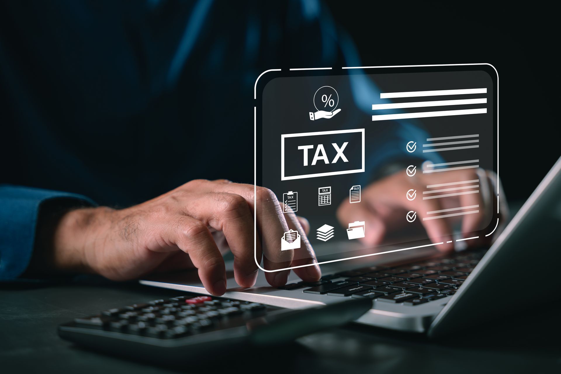 Close-up of an accountant's hands performing tax return prep for their client using a laptop.
