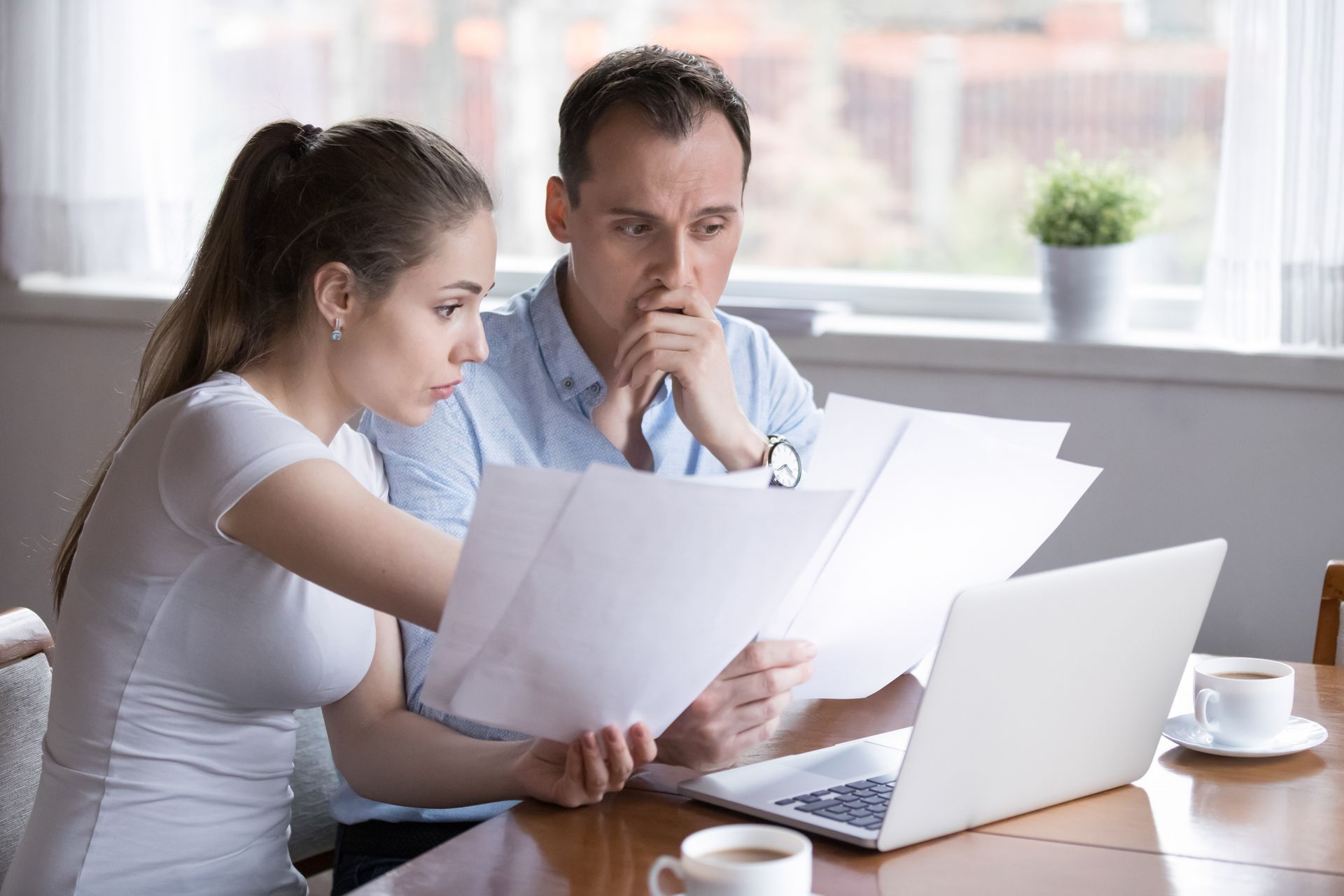 A person and person looking at papers Tax Return Preparation | Fremont, CA | Fremont Tax Experts