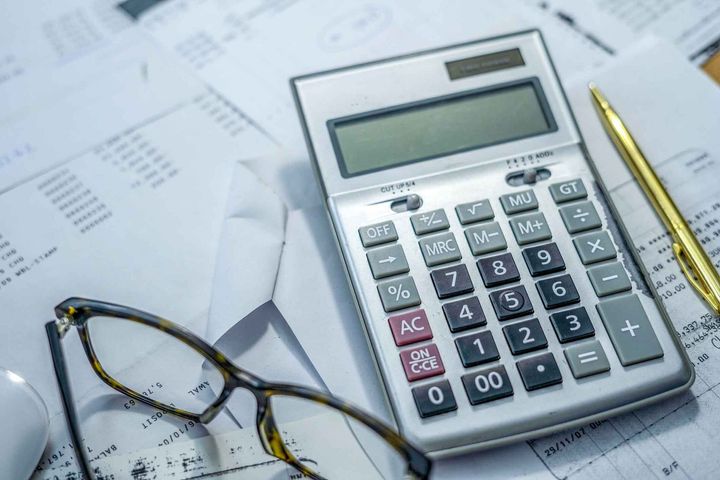 Calculator, glasses and pen on table — Fremont, CA — Finck, Rudnick & Company