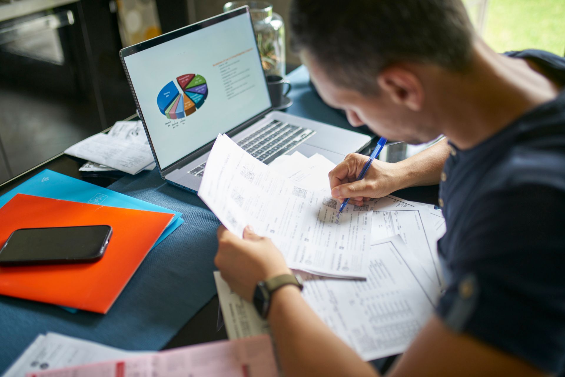 A man is reviewing his numbers to prepare his taxes.
