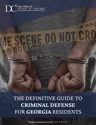 A person in handcuffs behind a crime scene tape with text for a criminal defense guide for Georgia residents.