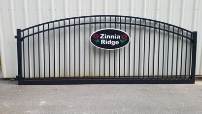 Black metal gate with arched top and