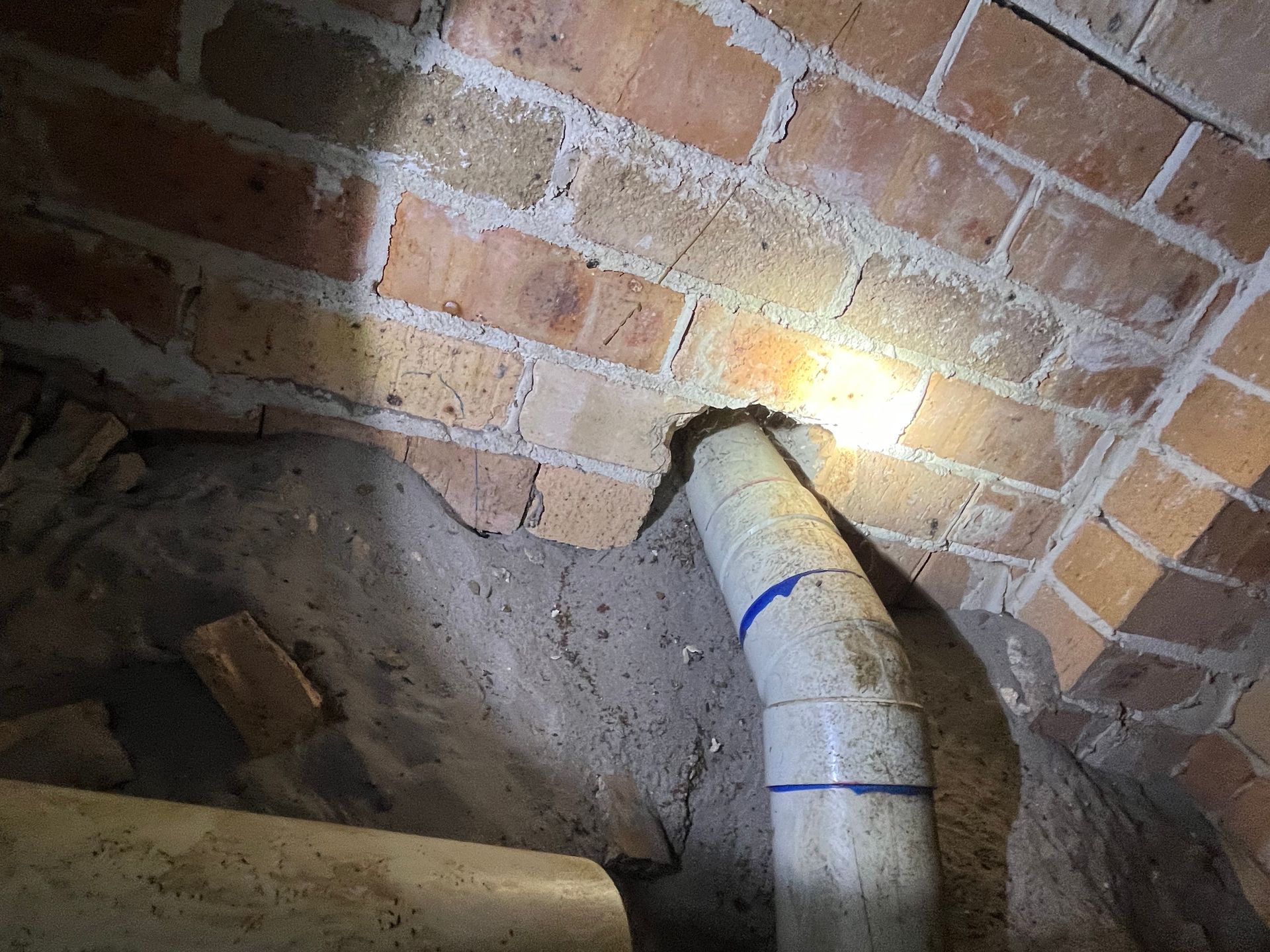 subfloor inspection showing entry path around PVC pipe a rodent inspection in Port Macquarie.